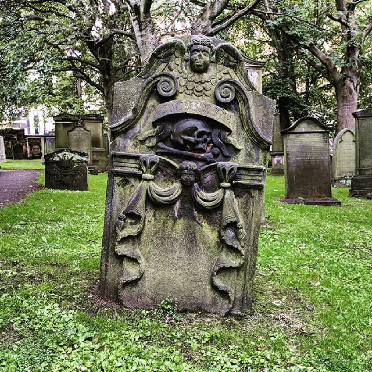 Skull-adorned gravestone in St. Cuthbert's graveyard, Edinburgh